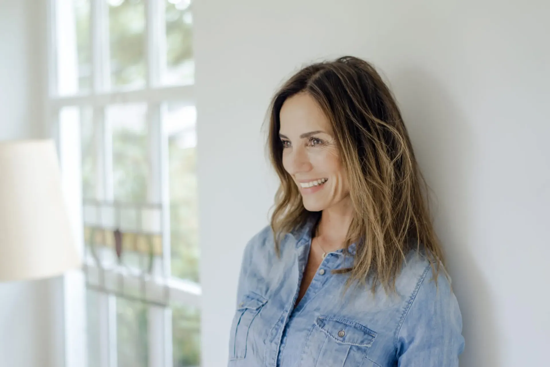 portrait-of-smiling-mature-woman-at-home-leaning-a-2022-03-08-01-24-48-utc-scaled